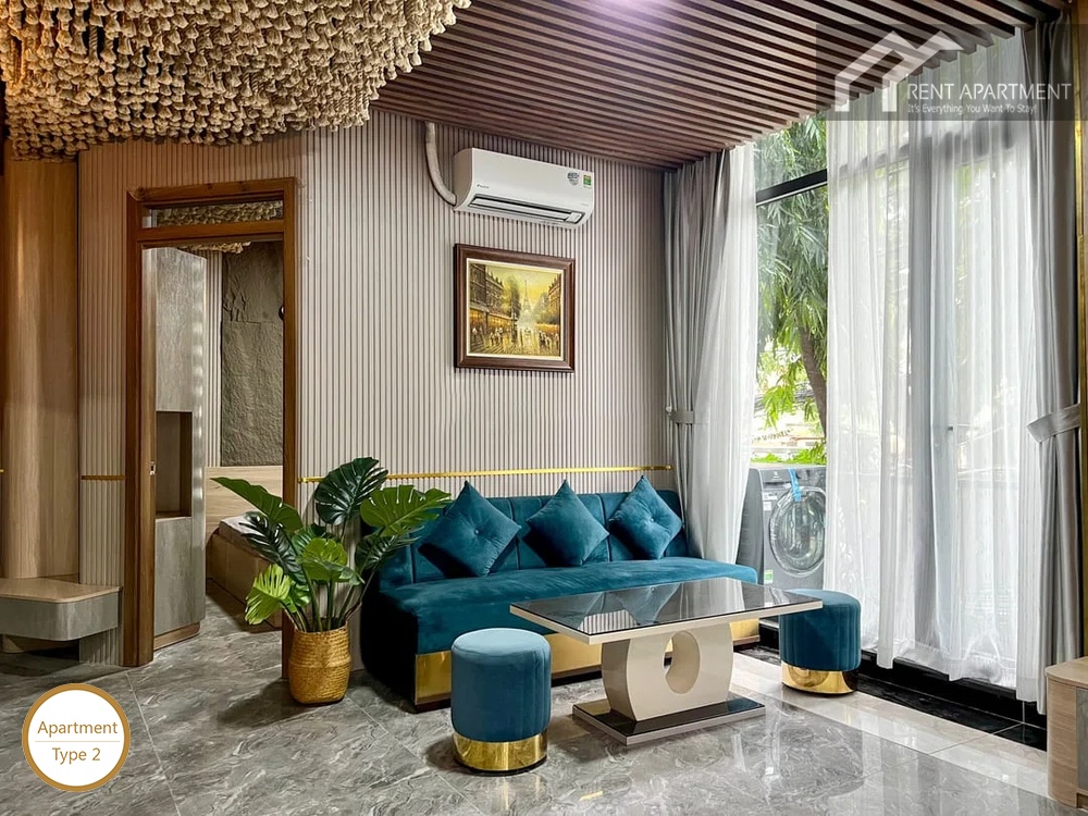 La Rosa 1-Bed comfortable living lounge with blue sofa coffee table and sheer curtain window