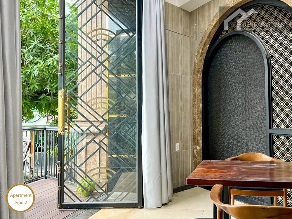 La Rosa 1-Bed covered terrace dining table with decorative glass door opening to balcony