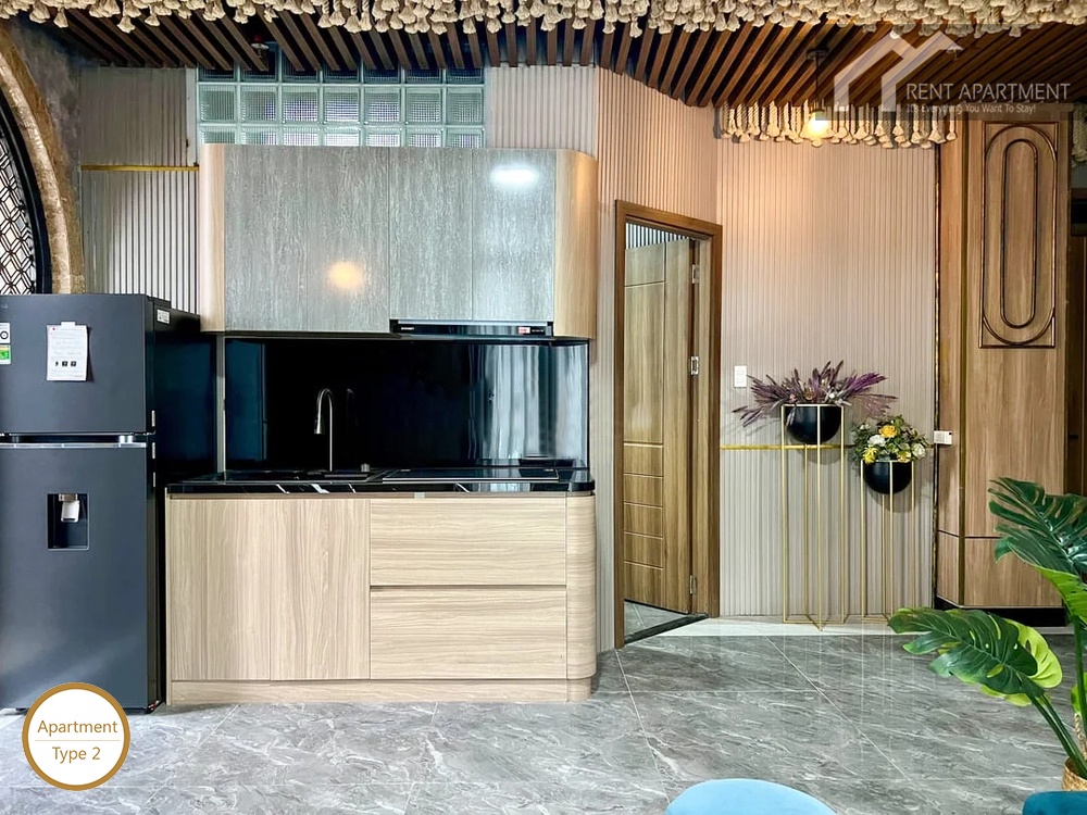 La Rosa 1-Bed modern kitchenette with wooden cabinets black backsplash and refrigerator
