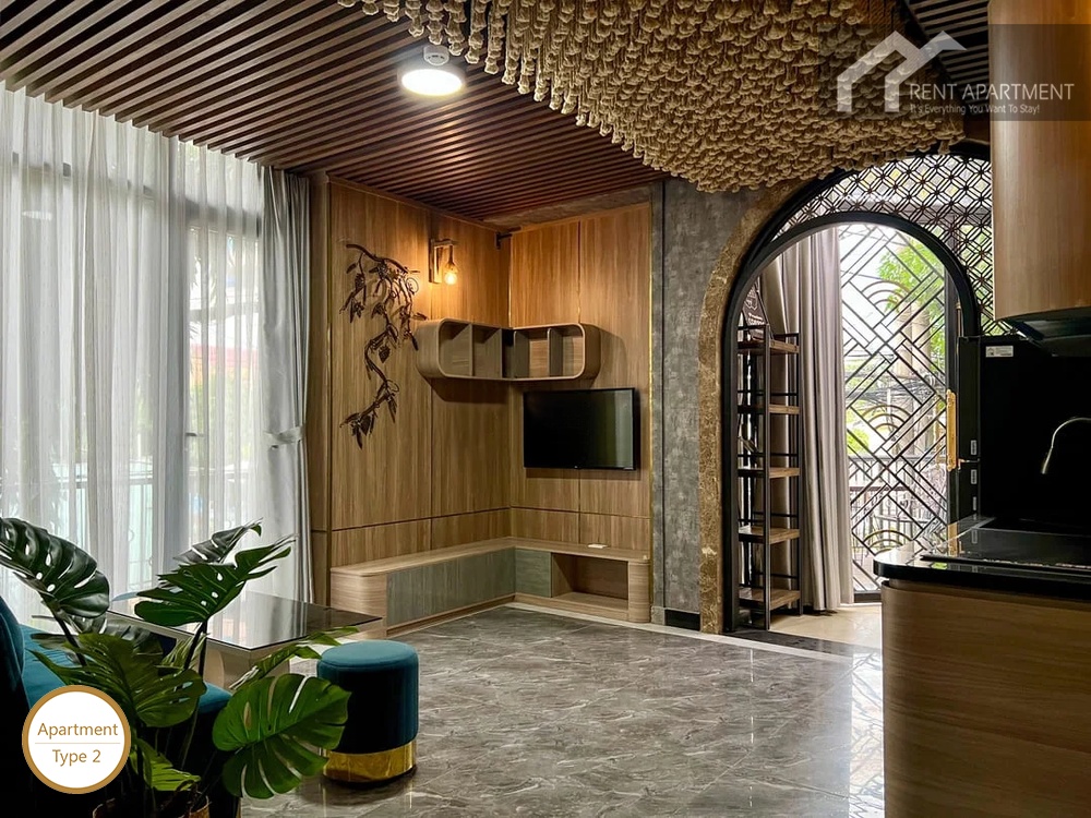 La Rosa 1-Bed open living room with wooden wall shelving tv setup and terrace entrance