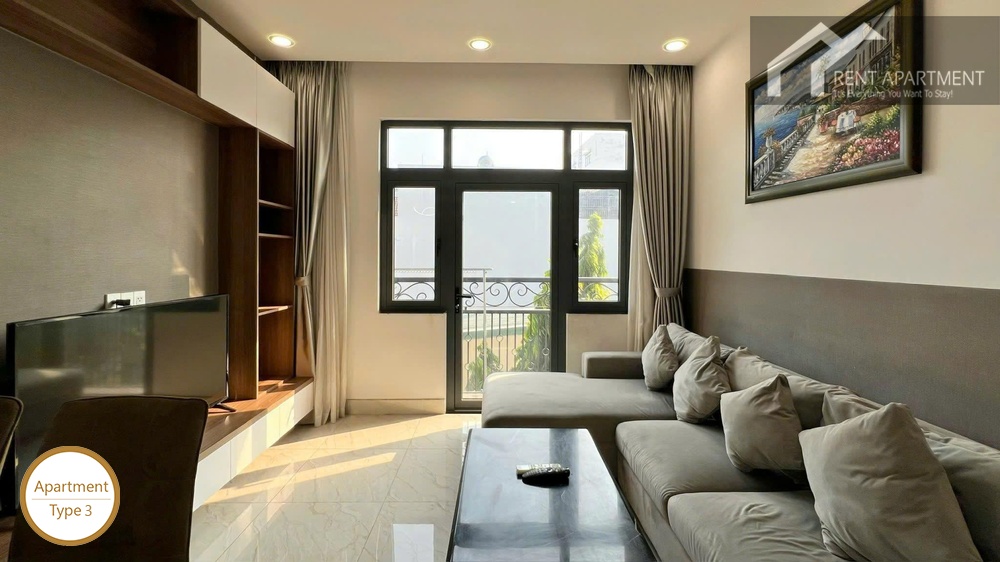 La Rosa 2-Bed bright living room with grey sectional sofa coffee table and balcony access
