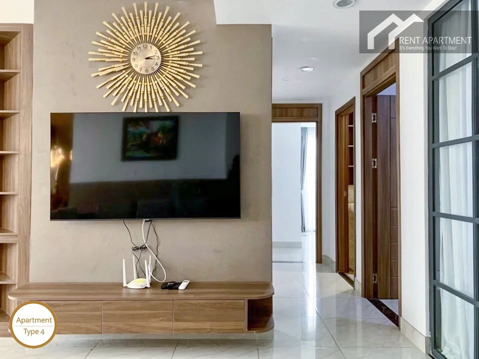 La Rosa 3-Bed living room tv wall with wooden console table and golden wall clock
