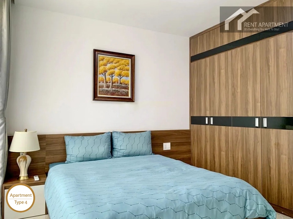 La Rosa 3-Bed second bedroom with bedside lamp and wooden wardrobe