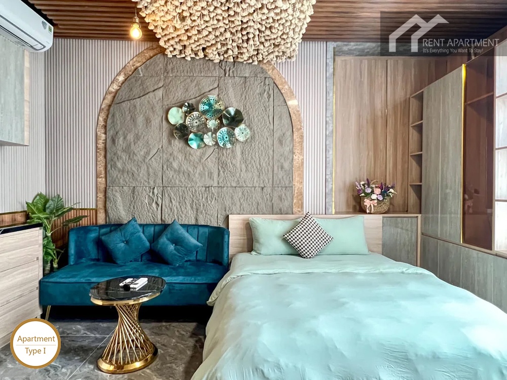 La Rosa Studio cozy bedroom area with blue sofa bed and stone wall decor