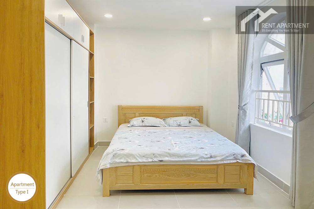 ID 2031 type 1 bright bedroom with wooden bed white sliding wardrobe and arched window