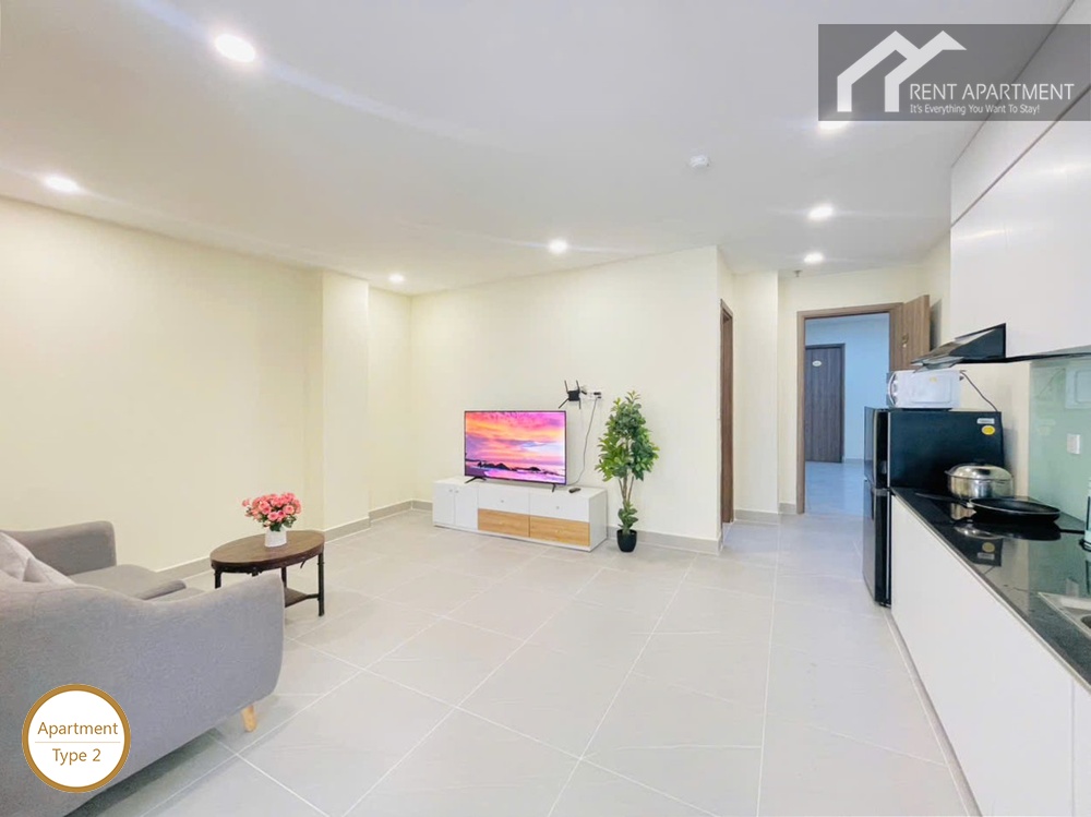 ID 2031 type 2 spacious living room with grey sofa tv console and kitchen counter