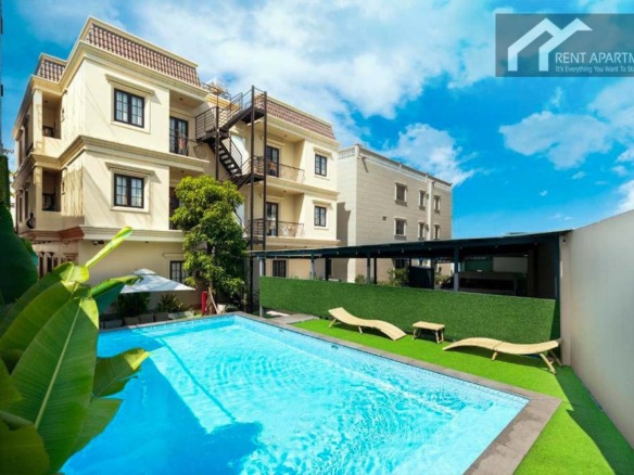 ID 2166 outdoor swimming pool with sun loungers and building view