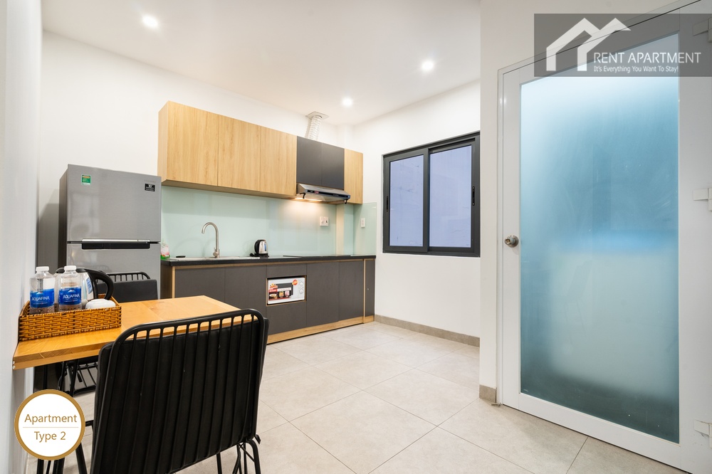 ID 2240 type 2 kitchen with wood upper cabinets fridge and dining table