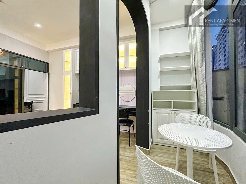 ID 2242 balcony seating area with white table and arched window frame