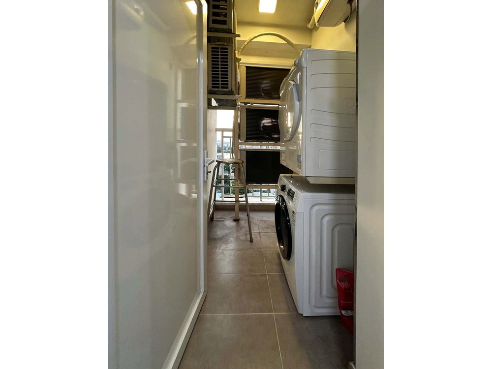 ID 2244 laundry area with stacked washing machine and dryer
