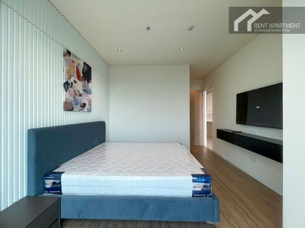 ID 2252 master bedroom with blue upholstered bed and mounted tv