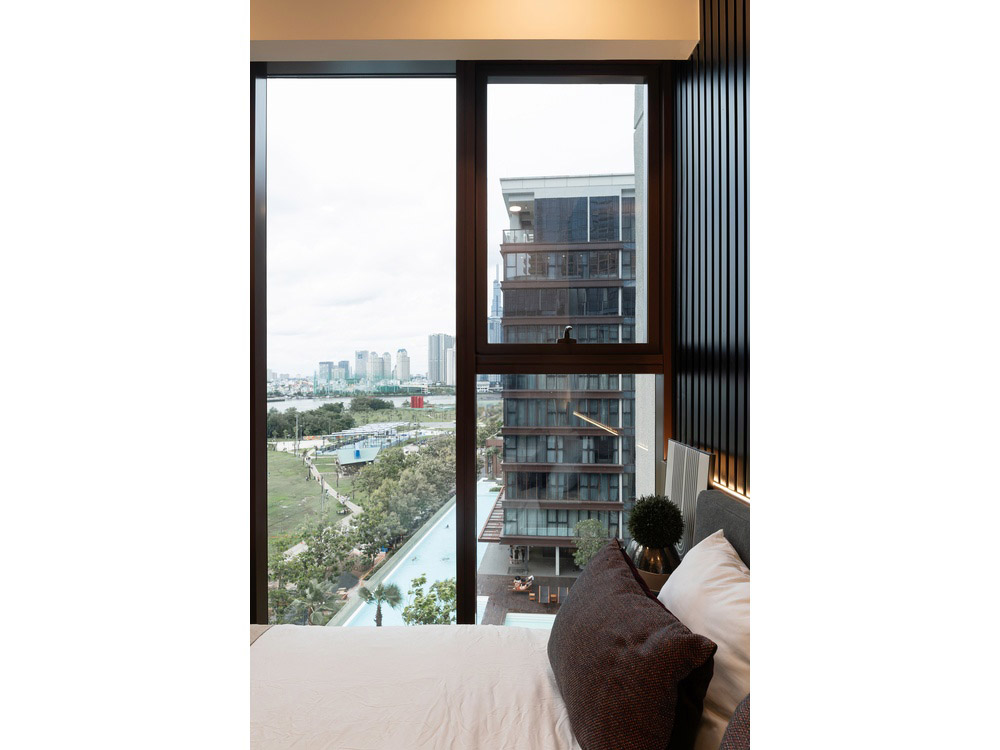 ID 2256 third bedroom window view overlooking resort pool landscape and river.