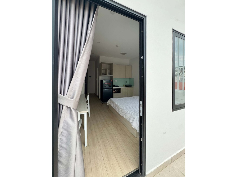 ID 2261 balcony view through open sliding door into bedroom and kitchen
