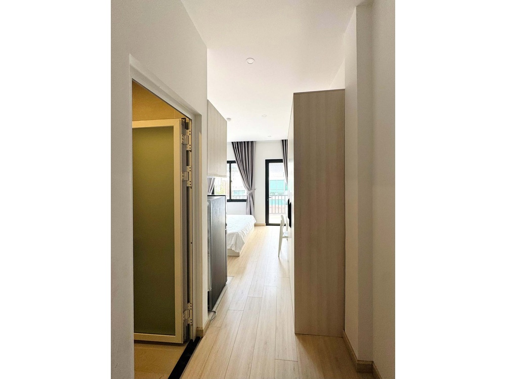 ID 2261 entrance hallway looking into bright bedroom with balcony door