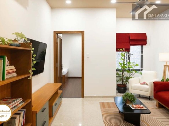 ID 2224 1br living room with red sofa tv unit bookshelf and doorway to bedroom