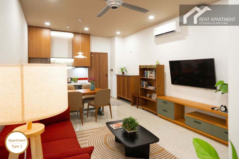 ID 2224 1br open concept living and dining space with red sofa tv console and kitchen